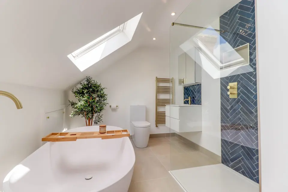 Loft bathroom with freestanding bath at Albert Road, Ashford TW15, a Surrey Build Group project