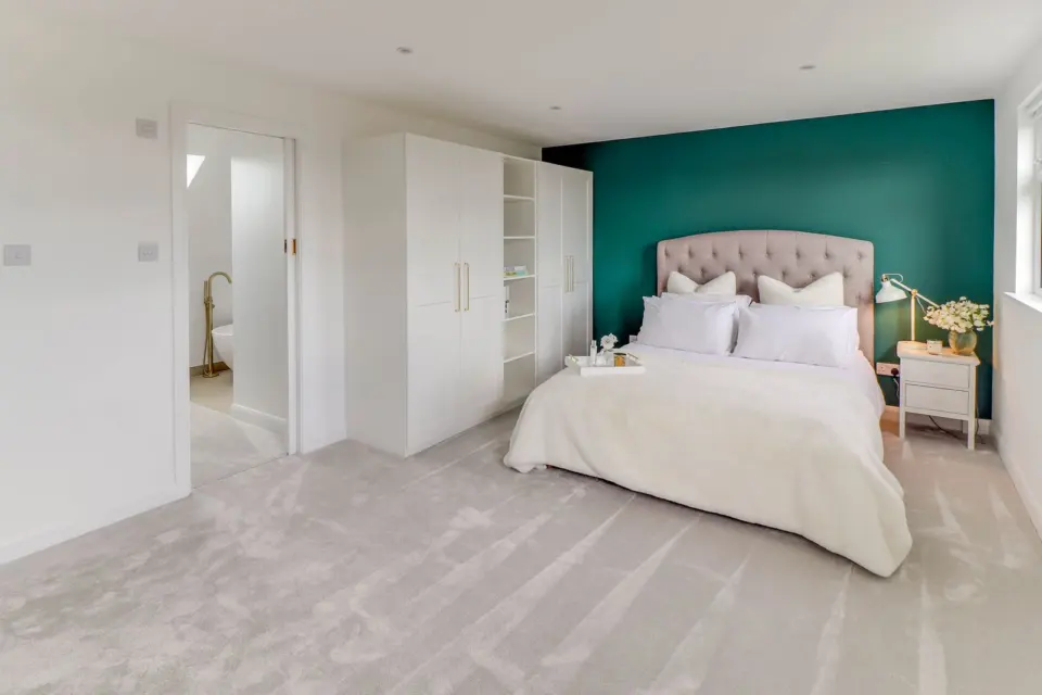 Loft bedroom with fitted wardrobes at Albert Road, Ashford TW15, a Surrey Build Group project