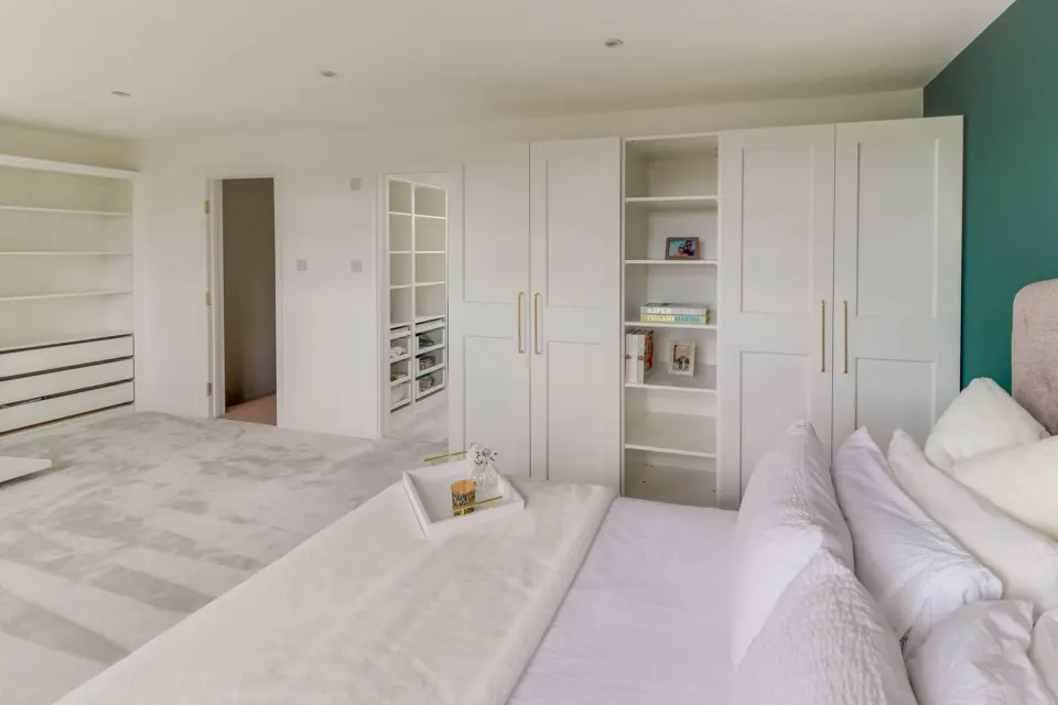 Dressing area with fitted storage at Albert Road, Ashford TW15, a Surrey Build Group project