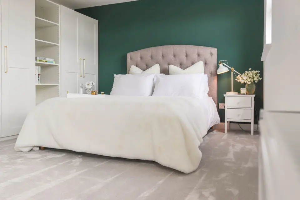 Bedroom with teal feature wall at Albert Road, Ashford TW15, a Surrey Build Group project