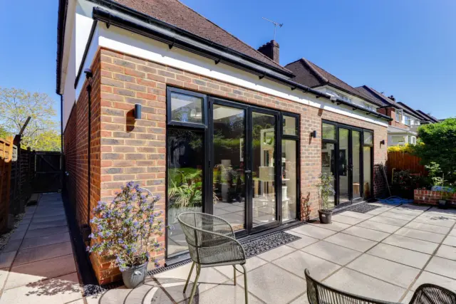 Brick extension with sliding doors at Ashenden, Guildford GU2, a Surrey Build Group project
