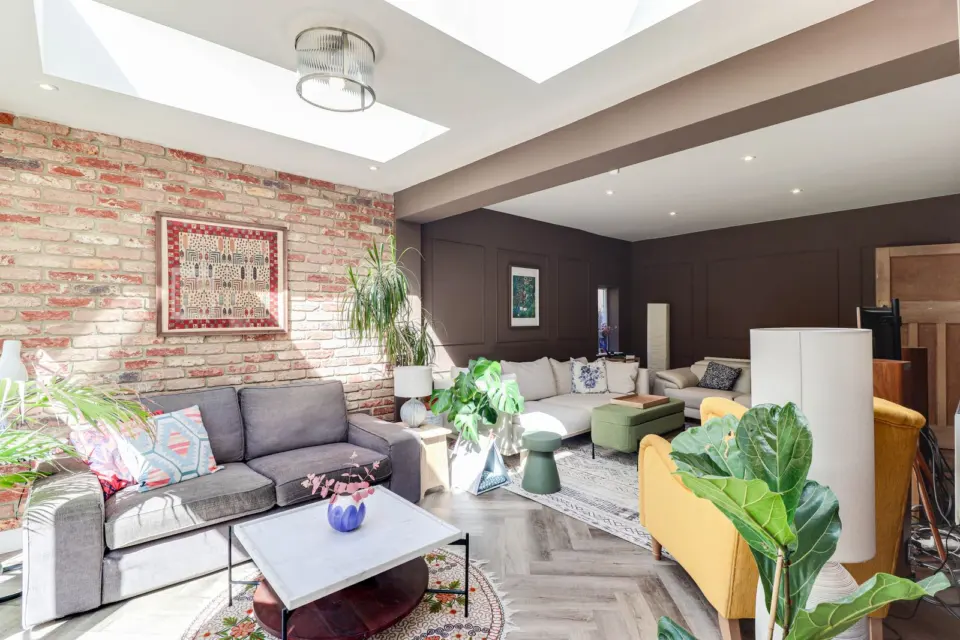 Living area with exposed brick wall at Ashenden, Guildford GU2, a Surrey Build Group project
