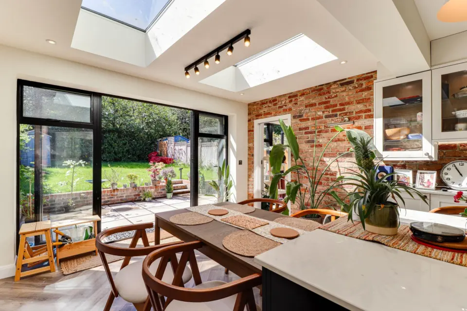 Dining area opening onto the garden at Ashenden, Guildford GU2, a Surrey Build Group project