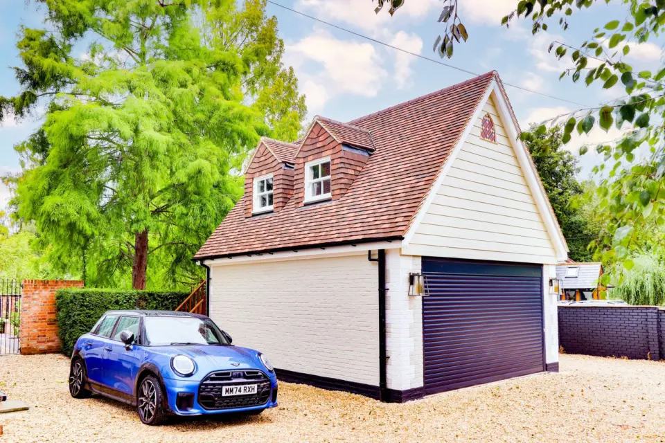 Cream clad garage and dormers at Mead House, Bramley GU5, a Surrey Build Group project