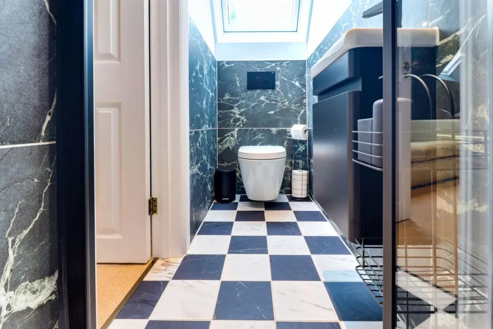 Shower room with chequerboard floor at Mead House, Bramley GU5, a Surrey Build Group project