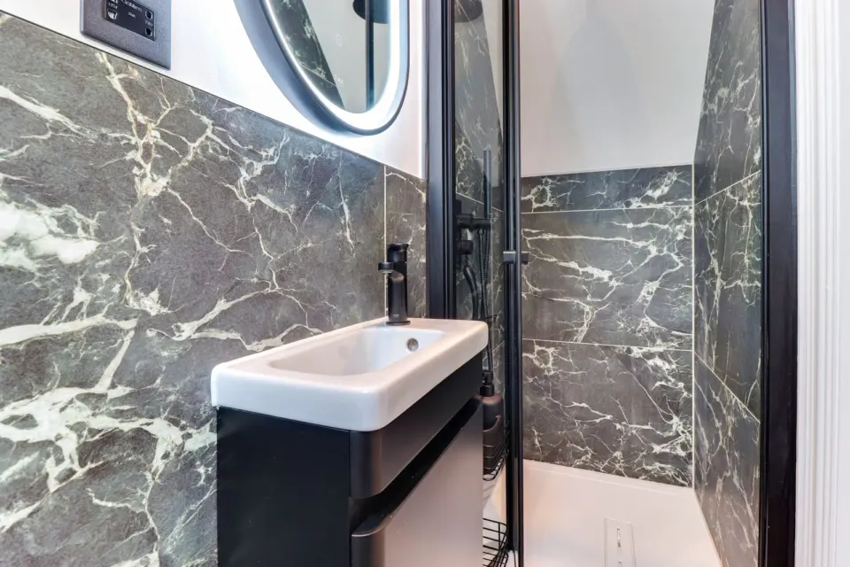 Vanity basin and illuminated mirror at Mead House, Bramley GU5, a Surrey Build Group project