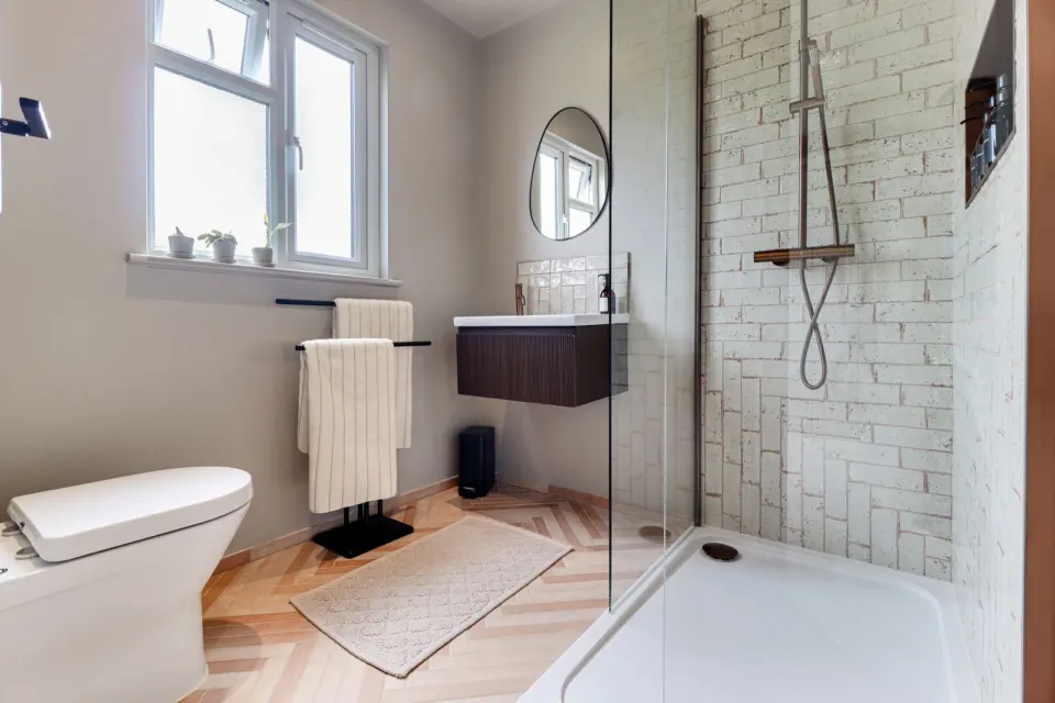 Ensuite with herringbone floor at Raeburn, Surbiton KT5, a Surrey Build Group project