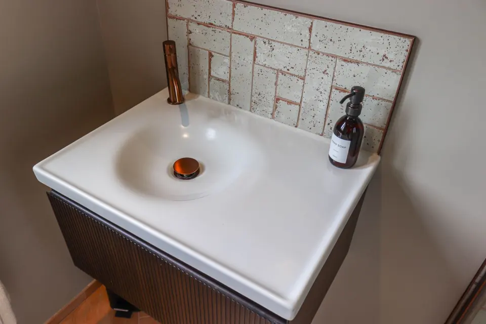 Vanity basin with copper detail at Raeburn, Surbiton KT5, a Surrey Build Group project