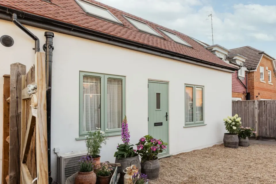 Rendered outbuilding and courtyard at The Bakehouse, Shalford GU4, a Surrey Build Group project