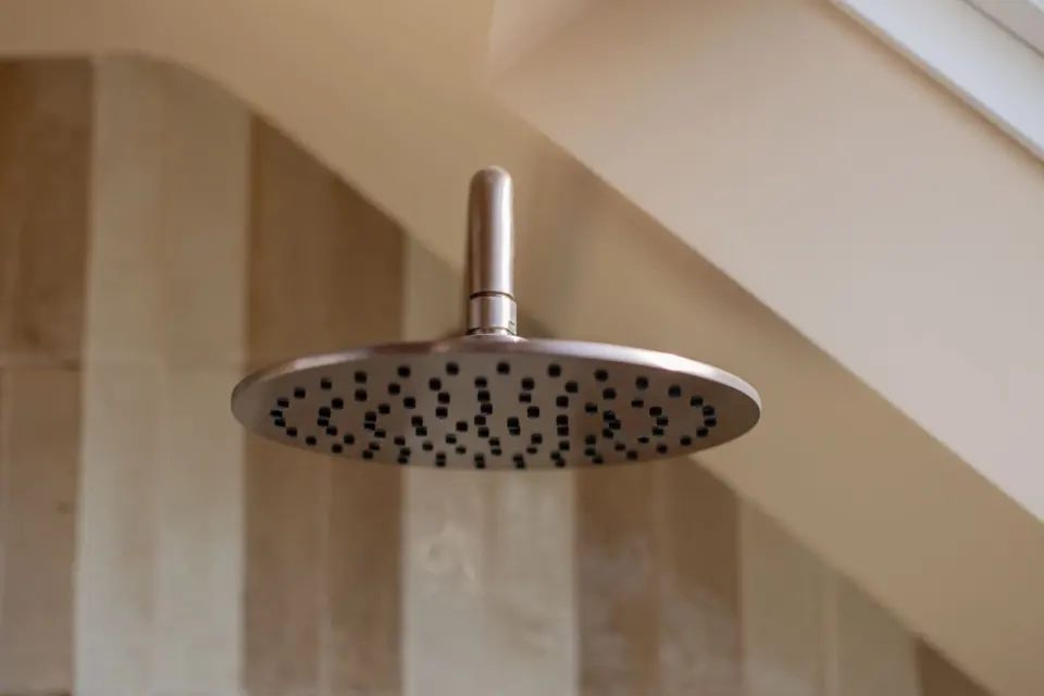 Brushed bronze shower head at The Bakehouse, Shalford GU4, a Surrey Build Group project