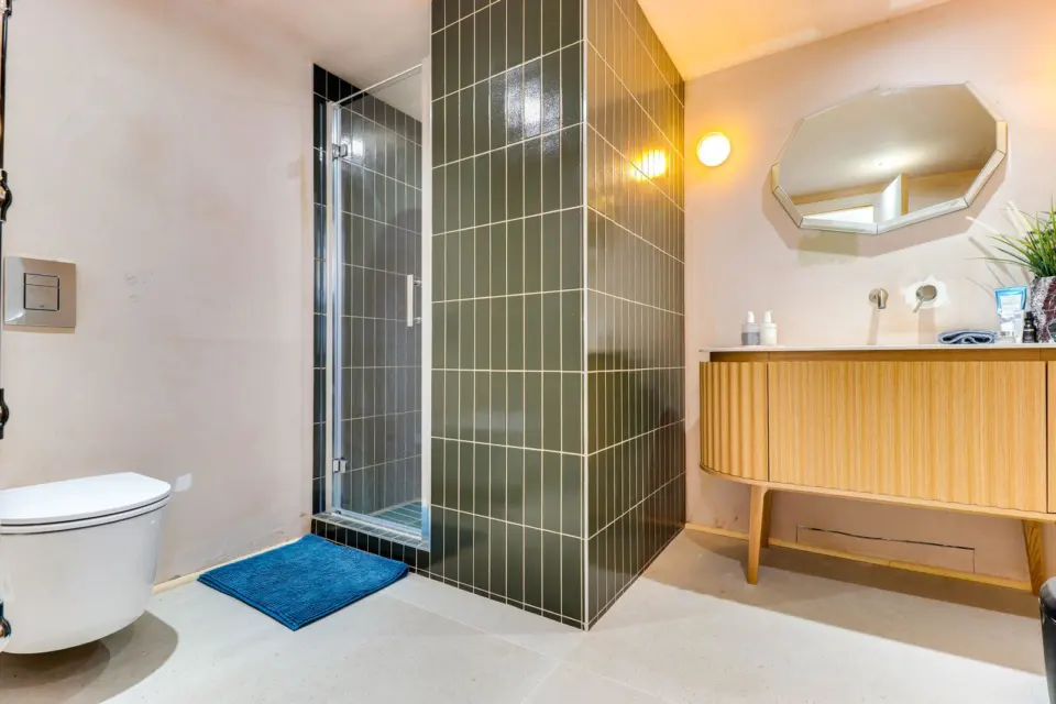 Shower room with green tiles at The Mount, Guildford GU2, a Surrey Build Group project