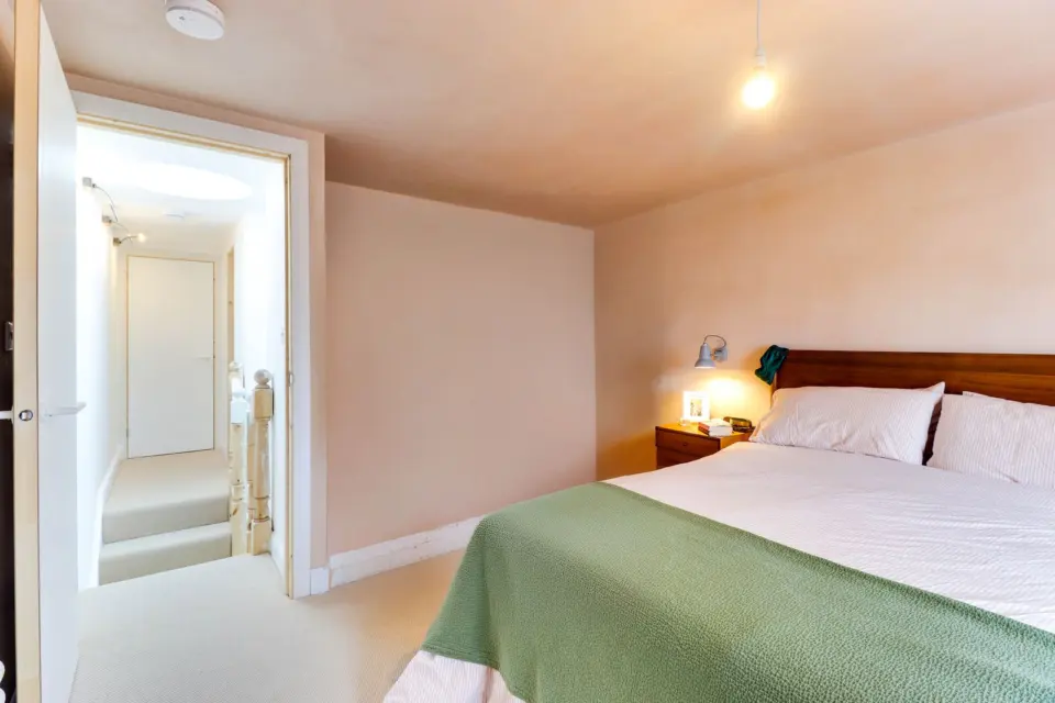 Bedroom with sage and oak tones at The Mount, Guildford GU2, a Surrey Build Group project